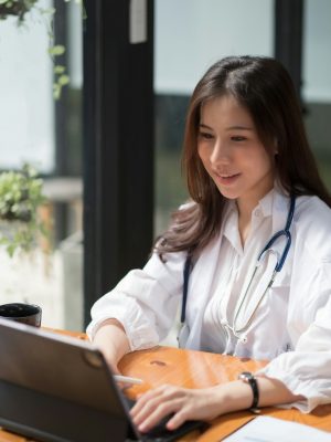Telemedicine concept. Asian female doctor talking with patient using laptop online video webinar